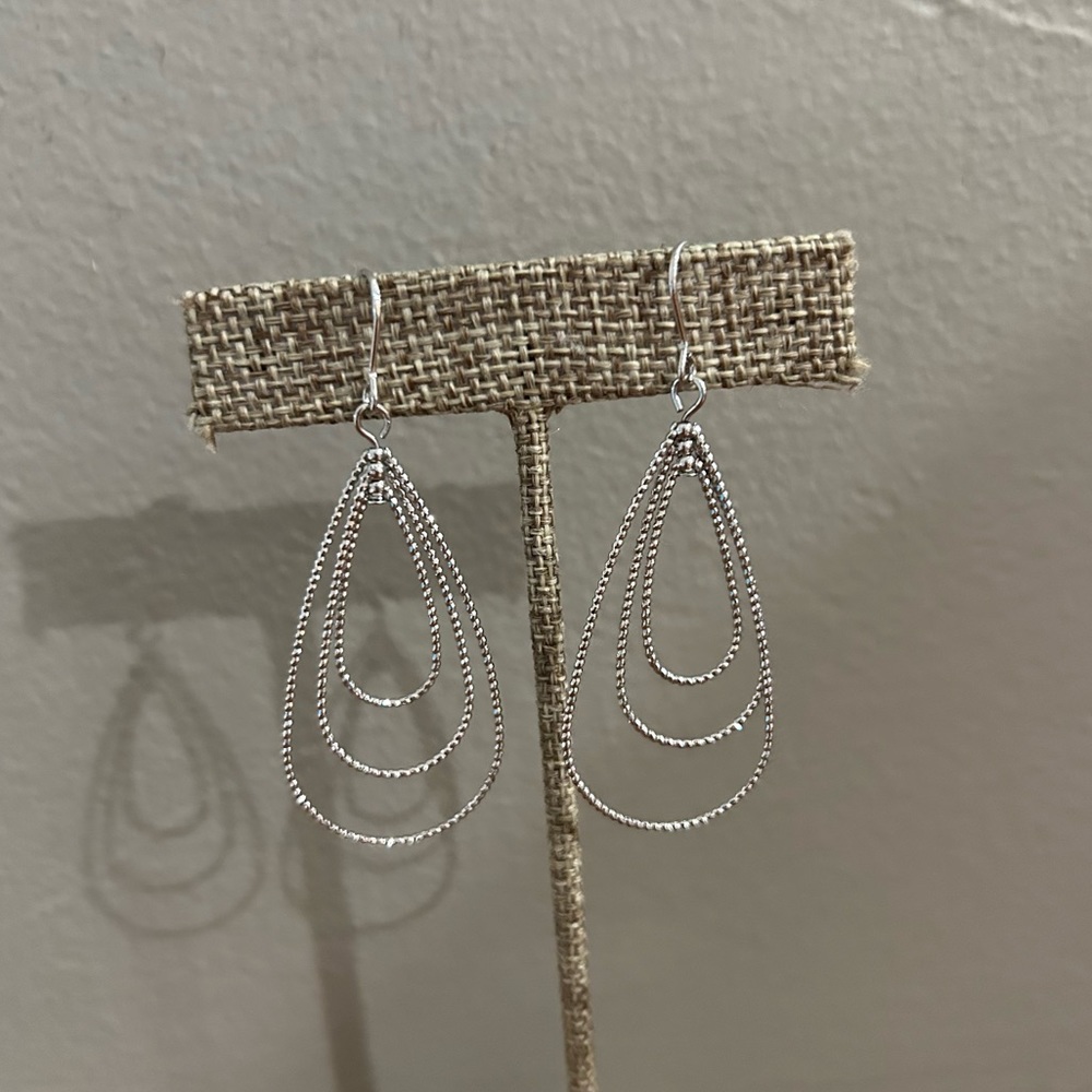 Silver toned dangling teardrop earrings